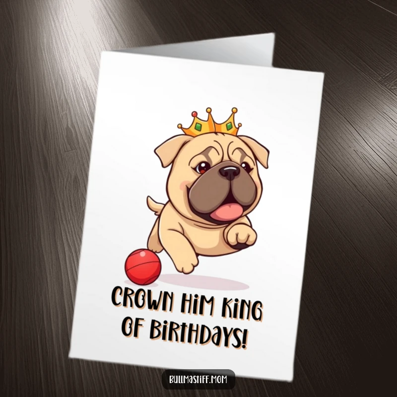 Funny Free Printable Birthday Card: A regal Bullmastiff in a tiny crown joyfully chases a red ball, ready to celebrate with a laugh.
