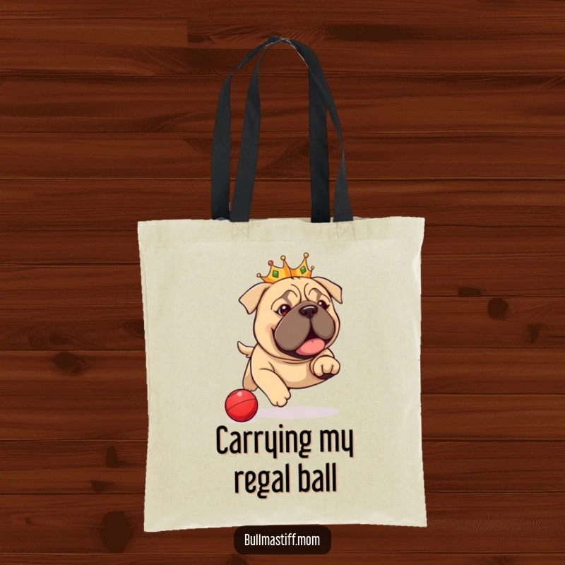 Funny Bullmastiff Tote Bag: A crowned dog gleefully chasing a red ball, showcasing a regal and humorous pet accessory.